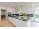 Modern kitchen with an island, black countertops, and plenty of white cabinetry at 2339 Prometheus Ct, Henderson, NV 89074