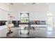 Contemporary kitchen features white cabinets, black countertops, and stainless steel appliances at 2339 Prometheus Ct, Henderson, NV 89074