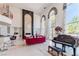 Spacious living room with high ceilings, grand windows, bar, and red sofas at 2339 Prometheus Ct, Henderson, NV 89074