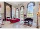 Elegant living room with high ceilings, large windows, and stylish red sofas at 2339 Prometheus Ct, Henderson, NV 89074