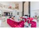 Bright living room with high ceilings, a bar, and two raspberry colored sofas at 2339 Prometheus Ct, Henderson, NV 89074