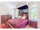 This bedroom features a large four-poster bed, hardwood furniture, and lots of natural light at 2339 Prometheus Ct, Henderson, NV 89074