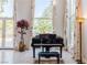Piano and plant in front of tall windows with decorated trim and natural light at 2339 Prometheus Ct, Henderson, NV 89074
