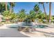 Backyard with a stunning pool, stone jacuzzi, and swaying palms for a relaxing oasis at 2339 Prometheus Ct, Henderson, NV 89074