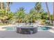 Resort-style backyard showcasing a swimming pool with stone hot tub and mature palms at 2339 Prometheus Ct, Henderson, NV 89074