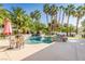 Backyard oasis with a tranquil pool and spa, accented by vibrant tropical foliage and comfortable seating at 2339 Prometheus Ct, Henderson, NV 89074