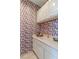 The wine room includes custom cabinetry, ample counter space, and distinctive wine-themed wallpaper at 2339 Prometheus Ct, Henderson, NV 89074