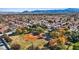 Expansive aerial view of a meticulously planned community with abundant green spaces and scenic mountain backdrop at 2547 Wolverton Ave, Henderson, NV 89074