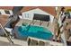 Aerial view showcasing a backyard pool and spa with covered patio in a well maintained yard at 2547 Wolverton Ave, Henderson, NV 89074