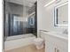 Modern bathroom featuring gray tiled shower and stylish vanity with white cabinets at 2547 Wolverton Ave, Henderson, NV 89074