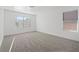 Spacious bedroom with plush carpet and large windows offering lots of natural light at 2547 Wolverton Ave, Henderson, NV 89074