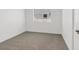 Empty bedroom with neutral carpet, white walls and trim, and a single window at 2547 Wolverton Ave, Henderson, NV 89074