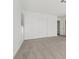 A bright bedroom featuring neutral carpet and white closet doors, with a window for natural light at 2547 Wolverton Ave, Henderson, NV 89074
