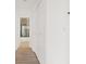 Bright hallway featuring wood floors, fresh white paint, and a view into the bathroom at 2547 Wolverton Ave, Henderson, NV 89074