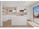 Well-lit kitchen with white cabinets, a central island, modern appliances, and sliding door access to outdoor space at 2547 Wolverton Ave, Henderson, NV 89074