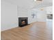 Spacious living room featuring a brick fireplace, bright window, and an open layout perfect for entertaining at 2547 Wolverton Ave, Henderson, NV 89074