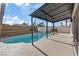 Backyard pool and spa area with covered patio, and modern horizontal wood fence at 2547 Wolverton Ave, Henderson, NV 89074