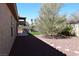 Side yard featuring artificial turf, rock landscaping, and BBQ perfect for outdoor entertaining at 2744 Pala Dura Dr, Henderson, NV 89074