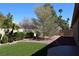 Backyard featuring artificial turf, rock landscaping, and a pathway offering a serene outdoor space at 2744 Pala Dura Dr, Henderson, NV 89074