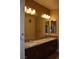 Bathroom with double sink vanity, granite countertop, and dark wood cabinets at 2744 Pala Dura Dr, Henderson, NV 89074