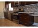 Modern kitchen with stainless steel appliances, stylish backsplash, and dark wood cabinets at 2744 Pala Dura Dr, Henderson, NV 89074