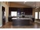Modern kitchen featuring dark wood cabinets, granite counters, and stainless steel appliances at 2744 Pala Dura Dr, Henderson, NV 89074