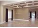 Open-concept living room with tiled flooring, stylish ceiling fan, and backyard access at 2744 Pala Dura Dr, Henderson, NV 89074