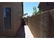 Side yard featuring privacy wall, tile pathway and gated access at 2744 Pala Dura Dr, Henderson, NV 89074