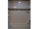Tub and shower combination with tile accents and built-in shelving at 2744 Pala Dura Dr, Henderson, NV 89074