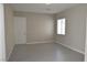 A modern bedroom features a window with blinds and tile floors at 2822 Poseidon Shore Ave, Henderson, NV 89052