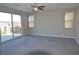 Bright and airy bedroom with carpeted floors, large windows, and access to a private balcony at 2822 Poseidon Shore Ave, Henderson, NV 89052