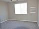 Cozy bedroom featuring neutral paint, plush carpet, large window, and built-in shelving at 2822 Poseidon Shore Ave, Henderson, NV 89052