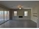 Spacious living room has tile flooring, fireplace, large windows, and sliding door to the backyard at 2822 Poseidon Shore Ave, Henderson, NV 89052