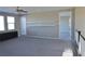 Versatile upstairs loft features plush carpeting, built-in shelves, and natural light from large windows at 2822 Poseidon Shore Ave, Henderson, NV 89052