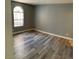 Well-lit bedroom with light gray walls, wood-look floors, and a window at 2967 Juniper Hills Blvd # 104, Las Vegas, NV 89142