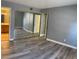 Spacious bedroom featuring modern gray walls and wood-look vinyl flooring at 2967 Juniper Hills Blvd # 104, Las Vegas, NV 89142