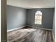 Bedroom showcasing hardwood floors, neutral gray paint, updated baseboards, and a window with natural light at 2967 Juniper Hills Blvd # 104, Las Vegas, NV 89142