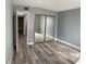 Neutral bedroom with double mirrored closet doors and wood-look floors at 2967 Juniper Hills Blvd # 104, Las Vegas, NV 89142