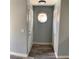 Hallway featuring gray walls, wood-look floors, and a round window at 2967 Juniper Hills Blvd # 104, Las Vegas, NV 89142