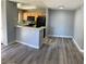 Living room and kitchen area featuring laminate flooring, neutral paint, and open concept layout at 2967 Juniper Hills Blvd # 104, Las Vegas, NV 89142
