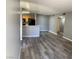 Open-concept living room and kitchen with sleek gray flooring and modern finishes at 2967 Juniper Hills Blvd # 104, Las Vegas, NV 89142