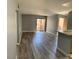Living room featuring laminate flooring, neutral paint, and sliding glass door access to the outdoors at 2967 Juniper Hills Blvd # 104, Las Vegas, NV 89142