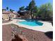 Inviting community pool with turquoise water, adjacent to a charming building with red tile roof at 2967 Juniper Hills Blvd # 104, Las Vegas, NV 89142