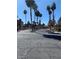 A street view inside the community featuring palm trees and buildings on either side at 2967 Juniper Hills Blvd # 104, Las Vegas, NV 89142