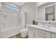 Bright bathroom featuring a shower-over-tub, a white vanity with a stone countertop, and a large mirror at 3512 Portiani Dr, Las Vegas, NV 89141