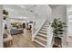 Spacious living room with a fireplace, a staircase, and lots of natural light from the sliding doors at 3512 Portiani Dr, Las Vegas, NV 89141