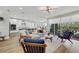 Bright living room with access to patio, adjacent to a modern kitchen at 3512 Portiani Dr, Las Vegas, NV 89141