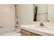 Bathroom with a tiled shower/tub combo, oak vanity, and white tile countertops at 3673 Ian Thomas St # 201, Las Vegas, NV 89129