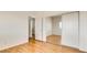 Bedroom featuring wood floors, mirrored closet and an entrance to the bathroom at 3673 Ian Thomas St # 201, Las Vegas, NV 89129