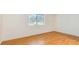 Bedroom with wood flooring, natural light from the large window at 3673 Ian Thomas St # 201, Las Vegas, NV 89129